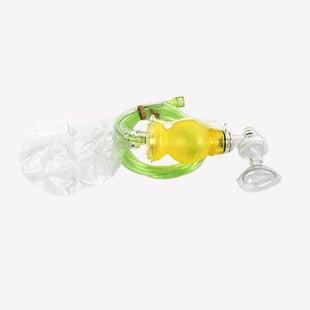 A medical airway adjunct set featuring a yellow bulb, green tubing, a clear face mask, and a clear plastic bag, displayed on a solid white background.